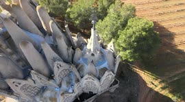 Beautiful monastery of Montserrat, with cultivated fields, bells and the blue sky in the background