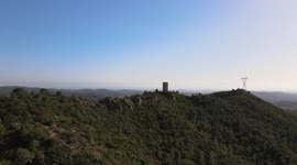 Beautiful monastery of Montserrat, with cultivated fields, bells and the blue sky in the background