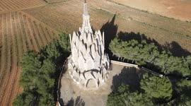 Beautiful monastery of Montserrat, with cultivated fields, bells and the blue sky in the background