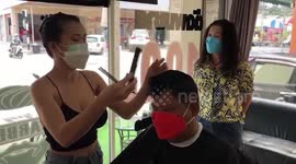 Sexy hairdresser drums up business at local Thai salon