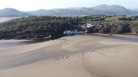 Drone footage panning across a Welsh estuary between Portmeirion and Harlech