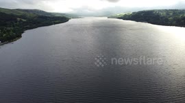 Aerial drone footage flying across Lake Bala (Llyn Tegid) in Wales late afternoon in Autumn
