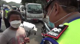 The Funny Action of a Little Child being ticketed by the police during a raid in Tanah Abang, Central Jakarta, Indonesia
