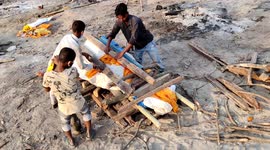 Group of children seen doing cremation work for COVID victims in India