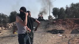 Palestinian protesters clash with Israeli troops following a demonstration against settlements in the West Bank village of Beita, near Nablus.