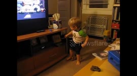 2 year old sings along and dances to animated Ghostbusters repeatedly stopping and restarting