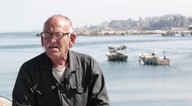 Palestinian fisherman, Rashad Al-Hassi, 77, works on his fishing net, at Gaza seaport