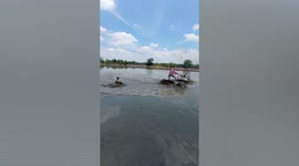 Boy goes ‘mudskiing’ in rice paddy in Thailand