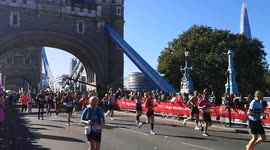 London Marathon Runners cross Tower Bridge at Mile 12, London, England, UK