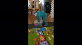 Baby takes a tumble when trying to close his play box