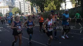 London Marathon Runners at Mile 13 and 22.5 Cross paths at Tower Bridge, London, England, UK