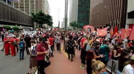 Brazilians in suits dance and sing in protest against President Bolsonaro in São Paulo, Brazil