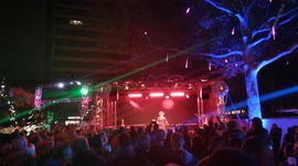 christmas festival in berlin. Folk songs are performed and sang on the stage. People walk, eat sausages, drink beer.