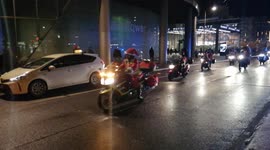 Santa Clauses ride a motorcycle through the streets of Berlin. Gave a festive mood to local residents.