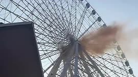 Smoke comes out of Ferris wheel at amusement park in eastern China
