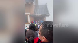 Hundreds of tourists stranded on China mountaintop due to poor weather during national holiday