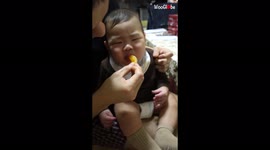 Hilarious moment baby eats orange for first time