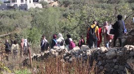 Palestinians participate in a march to explore the