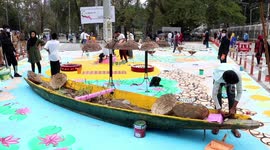 Students put up graffiti on the roads to beautify city in Northern India.