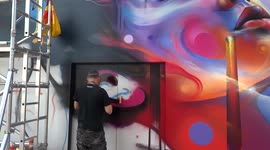 Street artist painting female portrait at Battersea Power Station Street Festival
