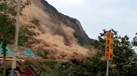 Landslide caused by continuous rainfall buries road in northern China