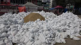 Bangkok residents prepare for floods with sandbags outside homes