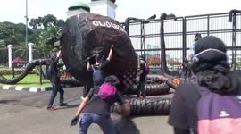 Greenpeace activists place giant octopus sculpture outside Indonesian parliament to decry 'energy corruption'