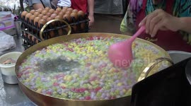 STREET FOOD: Thai vendors serve colourful mini-rice balls floating in sweet coconut milk