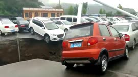 Vehicles plunge into sinkhole that opened up in car park in northern China