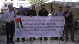 Palestinians take part in a protest against the United States and UNRWA signing a Framework for Cooperation, in the West Bank city of Hebron.