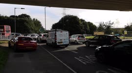 Car Waits For petrol Station Queue To Die Down