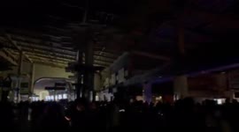 Shinagawa Station in Tokyo in total blackness from earthquake knocking out power.