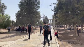 Palestinian Muslims attend Friday prayer in front of the Dome of the Rock Mosque