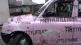 Pretty Little Thing pink unicorn taxi looks pretty outside Sainsbury's store in Kensington