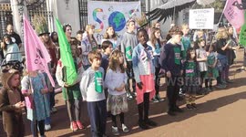 Young environmentalists sing before delivering petition to Buckingham Palace asking Queen to rewild royal land