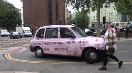Pretty Little Thing pink unicorn taxi looks pretty outside Sainsbury's department store in Kensington