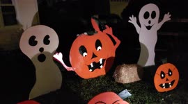 Handcrafted Wood and Animated Halloween Decorations at Night with a Scary Skull Animated Prop