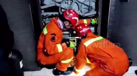 Dramatic firefighters evacuate five people stuck in an elevator in an shop in East Jakarta, Indonesia