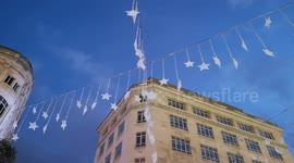 Christmas comes early to London as decorations hang above its main shopping street