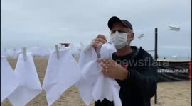 600 white handkerchiefs hung on Rio's Copacabana Beach to remember Brazil's 600,000 Covid deaths