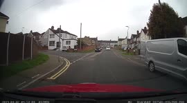Learner car turns left but oncoming car turns right going on the wrong side of the road to beat the learner