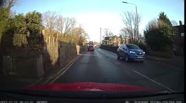 Impatient driver overtakes a line of cars near a zebra crossing driving on the wrong side of the road