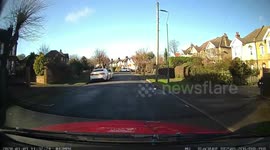 A Prious driver manages to drive his car on the top of an island in the middle of the road but the car is stuck