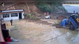 Chinese men sent fleeing when landslide crashes onto their house