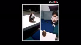 'Adorable baby girl having an interesting conversation with talking hamster toy'