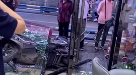 Chinese biker shatters hair salon's glass doors after pressing accelerator by mistake