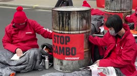 Group of eco-protesters block entrance of Downing Street, and road locking themselves in barrels