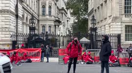 Greenpeace blocks Downing Street with oil barrels and Boris Johnson statue