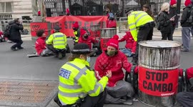 London police pull away Greenpeace protesters picketing Downing Street