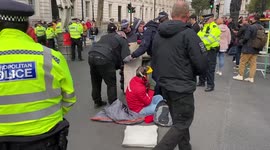 Greenpeace activists lock themselves to barrels outside Downing Street